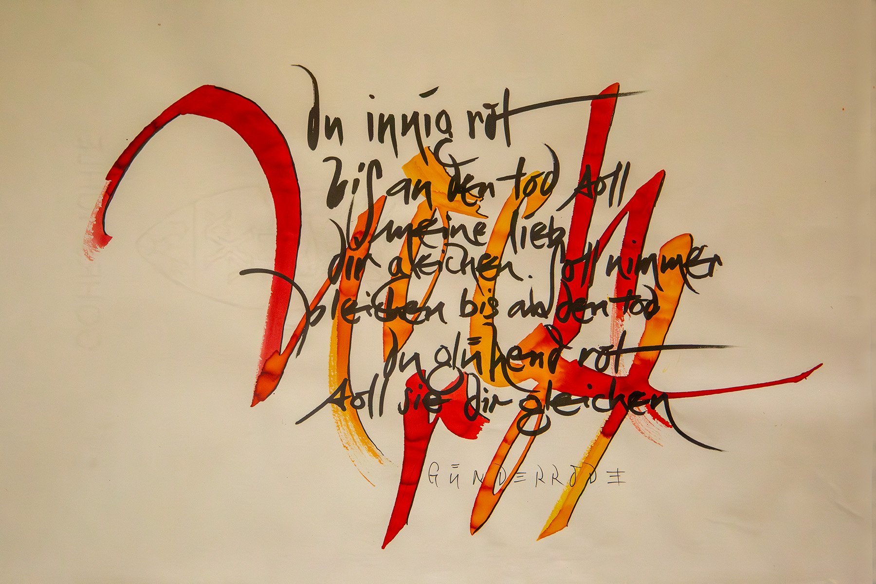 Blatt Papier mit schwarzem Text, dieser ist mit roten Lettern hinterlegt