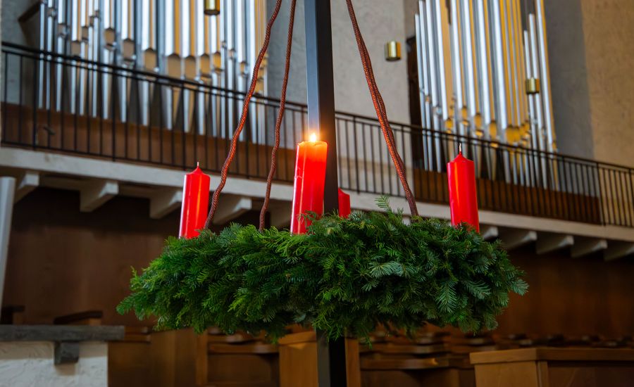 Adventskranz, bei dem die erste Kerze angezündet ist.
